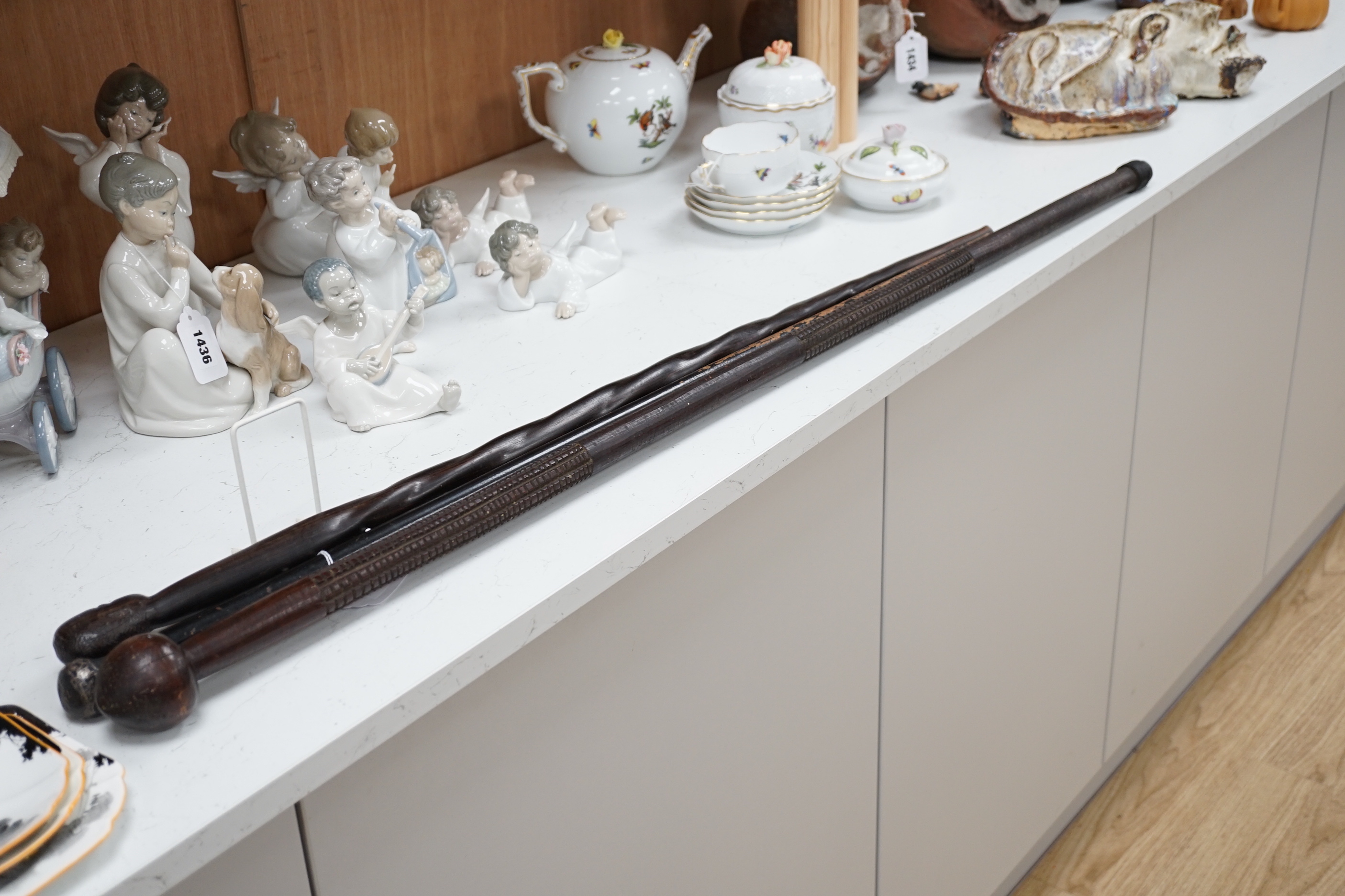 A silver topped walking cane and two African carved wood canes